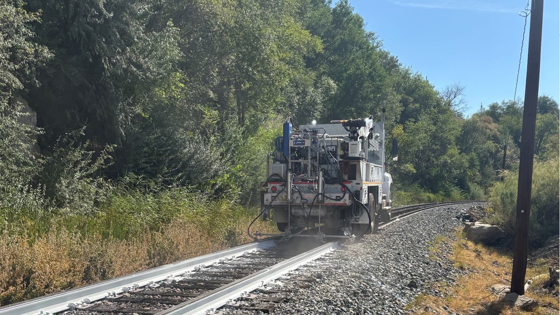 Painting the sides of railroad rails white to reduce derailment